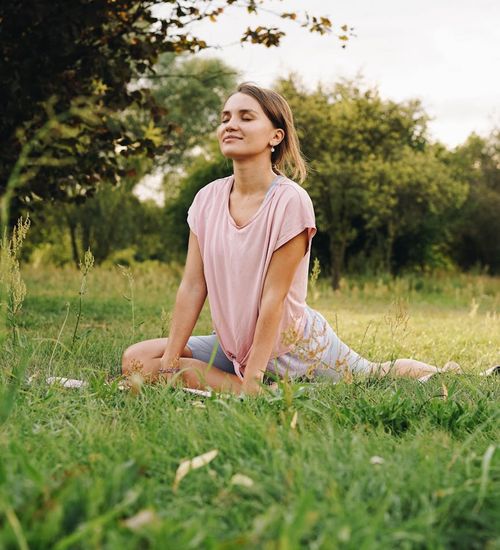 Woman practicing a peaceful yoga pose in a calm environment.